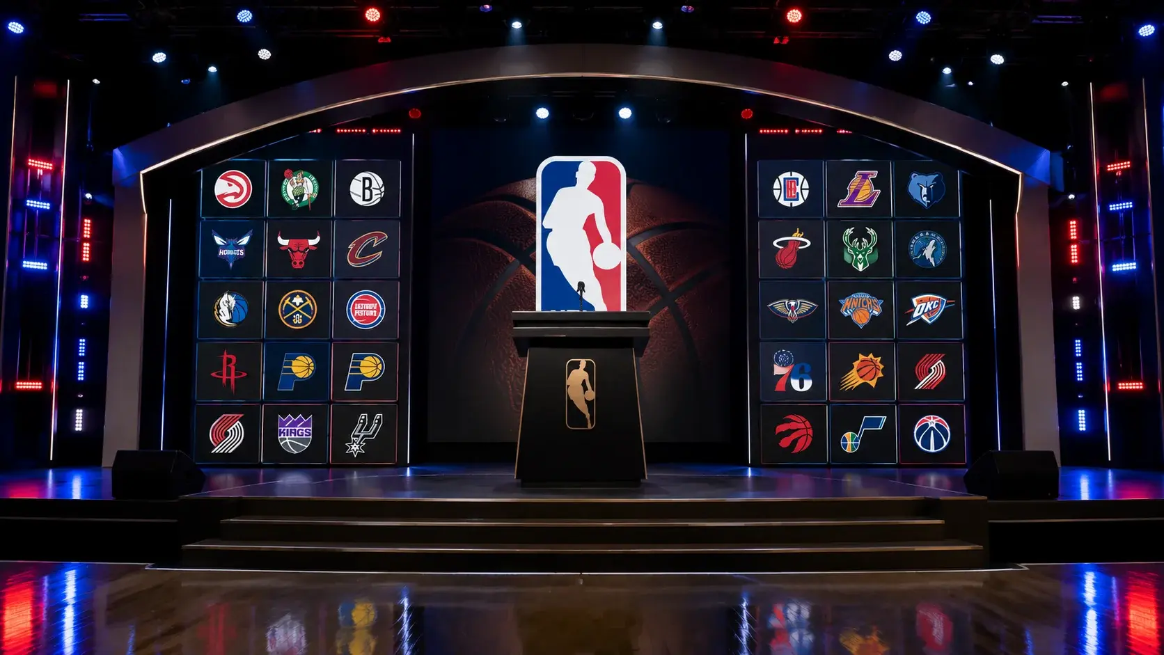 NBA Draft stage with the league commissioner at the podium and team logos displayed on screens behind him